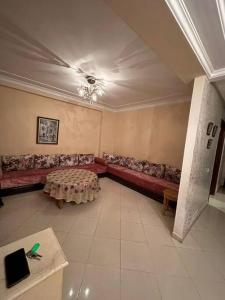 a living room with a couch and a table at Holikeys - El Jadida - 2 Ch - Sidi Bouzid 004 in El Jadida