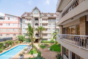 an apartment balcony with a swimming pool and a building at Eldon Suites & Apartments in Nairobi