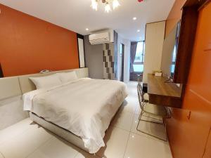 Postel nebo postele na pokoji v ubytování 安平商旅Choona Hotel Anping