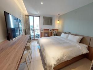 Postel nebo postele na pokoji v ubytování 安平商旅Choona Hotel Anping