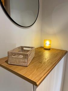 een doos op een tafel met een spiegel en een kaars bij Apartamento en el centro de Benasque in Benasque