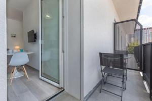 a balcony with a chair and a desk on a building at BO 40 SELF CHECK-IN - Appartamento Fiera-Tecnopolo in Bologna