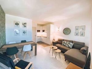 a living room with a couch and a table at n4 RELAXING SEAVIEW APARTMENT in Stintino