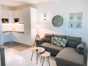 a living room with a couch and a table at n4 RELAXING SEAVIEW APARTMENT in Stintino +14 photos