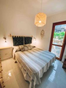 a bedroom with a large bed in a room at n4 RELAXING SEAVIEW APARTMENT in Stintino