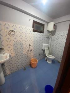 a small bathroom with a toilet and a sink at Freedom Cafe in Kalgha