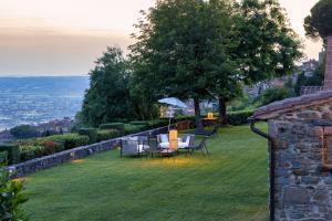 a table and chairs on top of a grass field at Mulino a Vento in Cortona