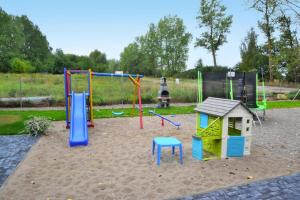 a playground with play equipment in a park at Comfortable holiday home for 4 people Ustronie Morskie in Ustronie Morskie