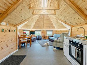 a kitchen and living room with a wooden ceiling at 1 Bed in Biggar 91252 in Libberton