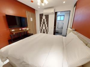 Postel nebo postele na pokoji v ubytování 安平商旅Choona Hotel Anping