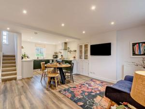 a living room with a table and a kitchen at 2 Bed in Lauder 91383 in Lauder
