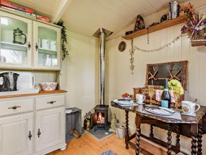 a kitchen with a table and a fire place at 1 Bed in Coleford 91373 in Bream