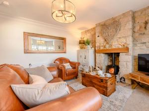 a living room with a couch and a fireplace at 2 Bed in Alnwick 91316 in Alnwick