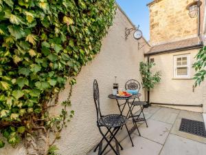 a small table and chairs sitting on a patio at 2 Bed in Alnwick 91316 in Alnwick
