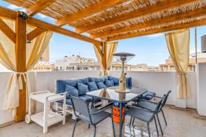 a patio with a table and chairs and a couch at Mar Báltico in Torrevieja