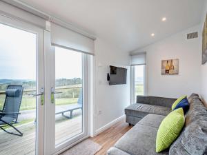 a living room with a couch and a sliding glass door at 1 Bed in Dalry 91418 in Dalry