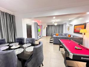 a living room with a red pool table in it at Tribeca pod (3 bedroom with swimming pool) V.i Lagos in Lagos