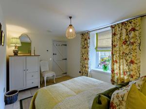 a bedroom with a bed and a window at 1 Bed in Hawick 91437 in Denholm