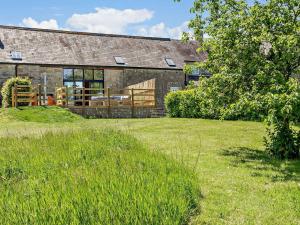 a brick building with a grass field in front of it at 4 Bed in Melbury Abbas 91456 in Melbury Abbas