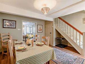 a dining room with a table and a staircase at 2 Bed in Middleham 91639 in Middleham