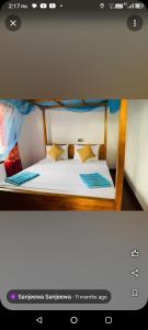 a bedroom with a bed with white sheets and pillows at Muru's Place in Dickwella