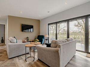 a living room with two couches and a table at 4 bed property in Worcester 91592 in Worcester