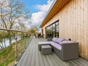 a wooden deck with a couch and a table at 4 bed property in Worcester 91592 in Worcester