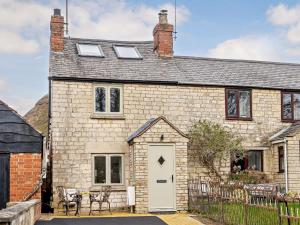 an old stone house with a white door at 2 Bed in Gloucester 91603 in Matson