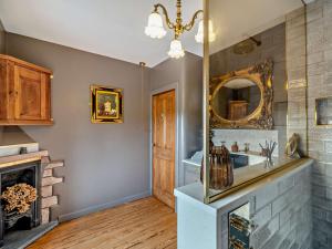 a bathroom with a fireplace and a sink and a mirror at 1 Bed in Barrow-in-Furness 91590 in Barrow in Furness