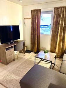 a living room with a flat screen tv and a couch at Appartment close to the city, ocean and mountains -Tromsø in Tromsø