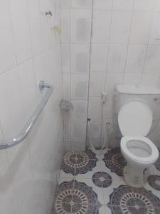 a bathroom with a toilet and a tiled floor at LMD Apartments in Kololi