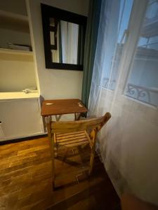 a wooden bench sitting in front of a window at Loft sur Notre-Dame/Saint-Michel in Paris