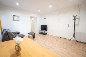 a living room with a couch and a table at Budget apart city centre with parking in Charleville-Mézières