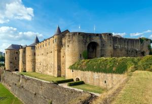 a large castle with grass on top of it at Budget apart city centre with parking in Charleville-Mézières