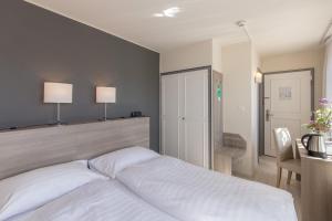Postel nebo postele na pokoji v ubytování Hôtel de la Rose
