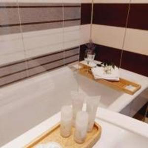 a bathroom with a bath tub with a tray of candles at Cozy apartment in the center of Bucharest in Bucharest