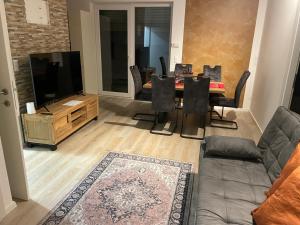 a living room with a table and a television at Sorinas Home - Comfortable Apartment near Graz - Free Parking in Wagersbach