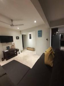 a living room with a couch and a tv at Entire 3 bedroom Fully Furnished House, 6 Guests in Suva