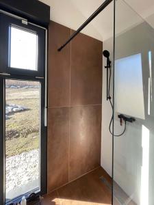 a shower with a glass door in a bathroom at RA House Plitvice Lakes in Bročanac
