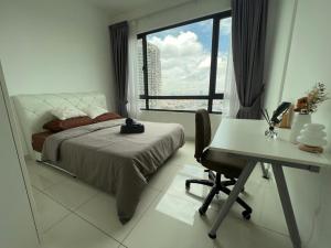 a bedroom with a bed and a desk and a window at Greenfield Residence - Sunway, Taylors, One Academy in Petaling Jaya