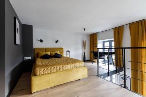 a bedroom with a yellow bed and a balcony at GA Wroclaw&Jana Pawla- Free Parking in Wrocław