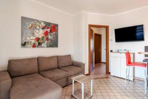 sala de estar con sofá y mesa en I BROLI - lovely nest with pool, en Polpenazze del Garda