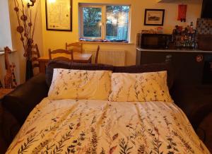 a bedroom with a bed with a comforter at Cosy cottage in picturesque Hawkshead in Hawkshead