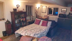 a living room with a bed and a book shelf at Cosy cottage in picturesque Hawkshead in Hawkshead
