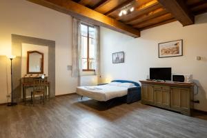 a bedroom with a bed and a television in it at Apartments close to Duomo in Florence