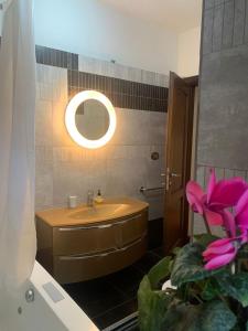 y baño con lavabo y espejo. en Flavia Apartment, en Roma