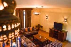 a living room with a couch and a television at Port Ghalib Marina Residence Suites in Port Ghalib