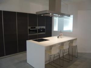 a kitchen with a white island with stools at B&B Loft Jamar Gare Du Midi in Brussels