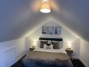 a bedroom with a large bed with two night stands at Village Lodge in Middlesbrough