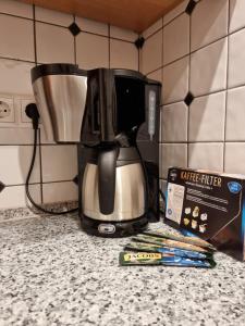 a coffee maker on a counter next to a box at FeWo Sundernblick in Haltern